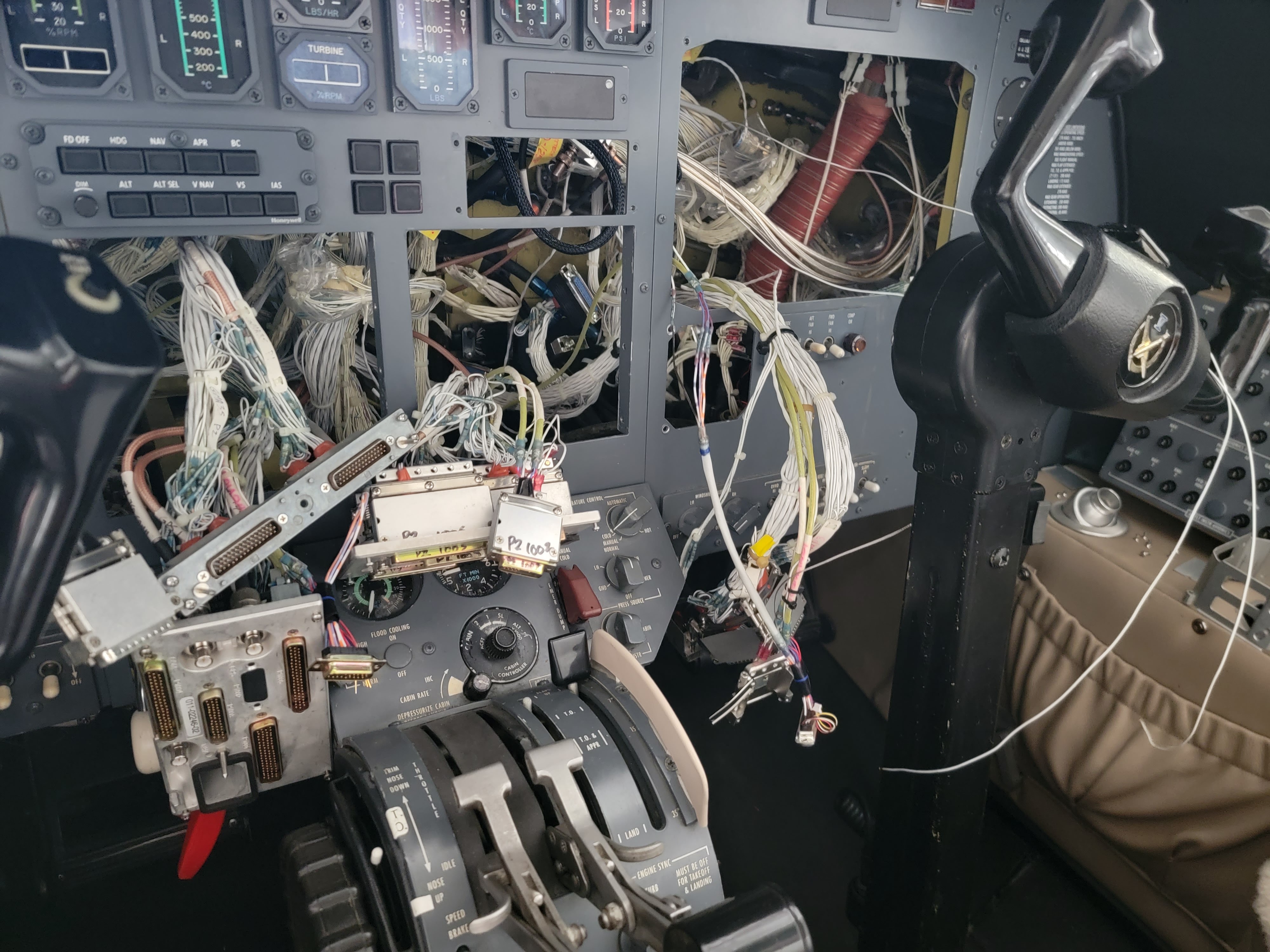 taken apart airplane with visible wiring